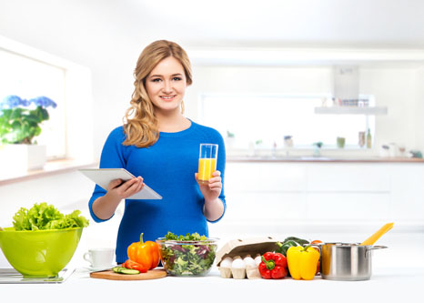 Women with nutritious food in kitchen